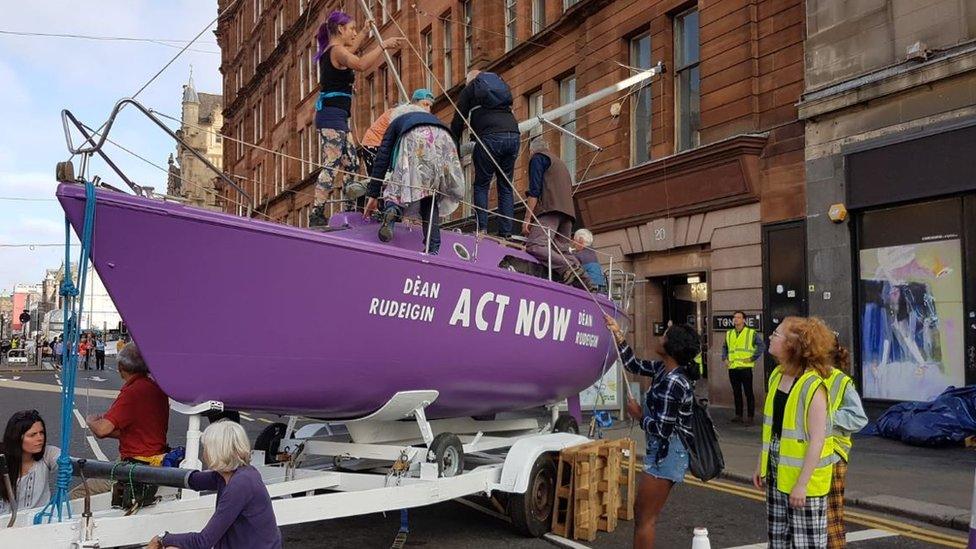 A purple boat blocks a road in Glasgow