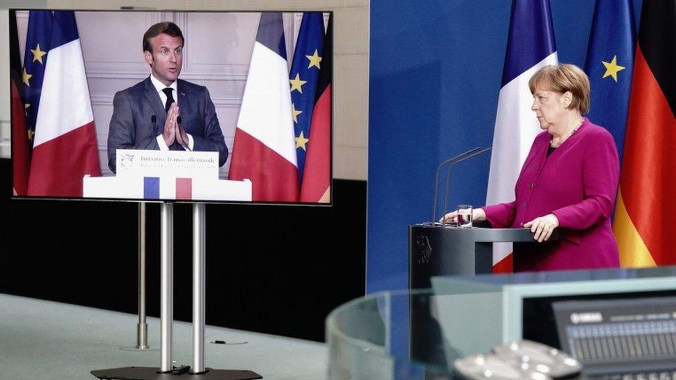 German Chancellor Angela Merkel listens during a joint press conference with French President Emmanuel Macron on 18 May