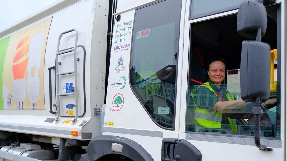 A female Veolia waste truck driver