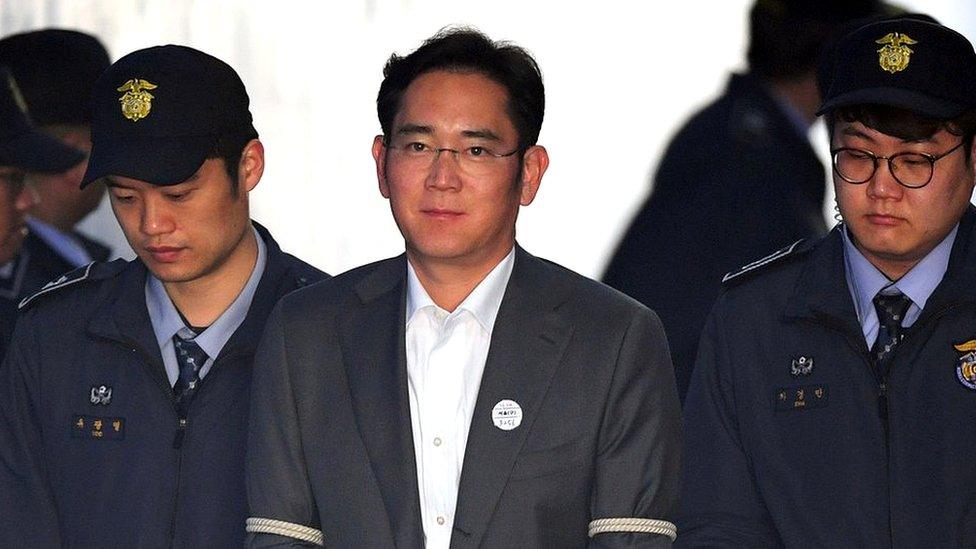 Lee Jae-yong escorted by prison guards in April