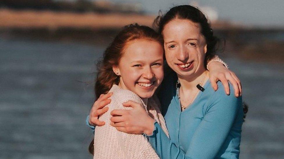 Maia-who-is-deaf-and-her-sister-annabel-on-a-beach