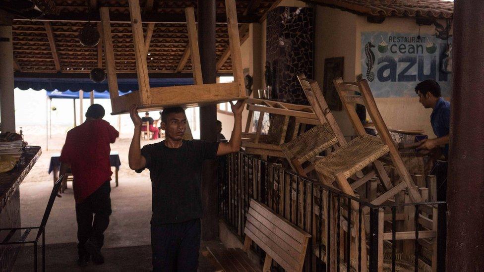 Man carries chairs in Mexico