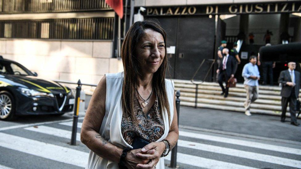 Egle Possetti, president of the committee representing the families of the 43 victims, talks to journalists outside the Genoa courthouse