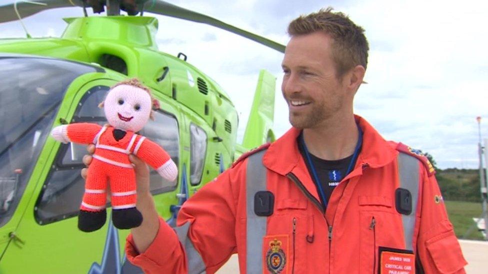 Ambulance crew member with knitted doll