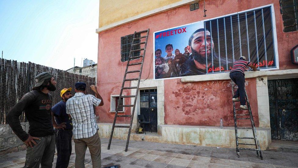 A poster calling for Tauqir Sharif's is placed on a wall in Atmeh, Syria (1 July 2020)