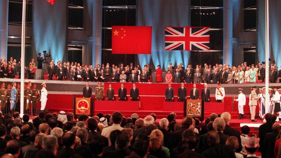 A general view of the handover ceremony showing the Chinese flag (L) flying after the Union flag (R) was lowered in Hong Kong in this July 1, 1997 file photograph.