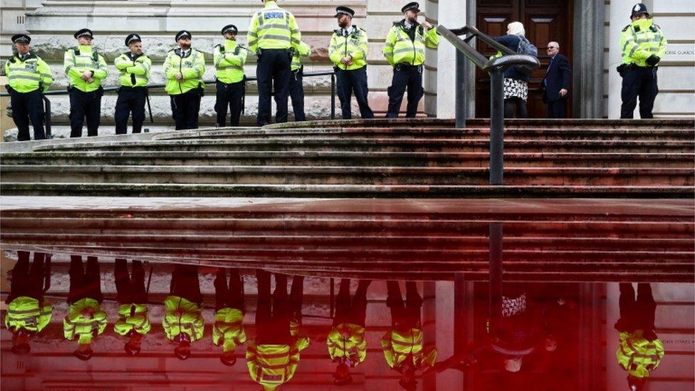 Police stands in front of the Treasury building during an Extinction Rebellion protest in London