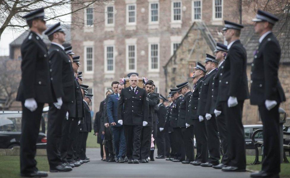 Police carry the coffin