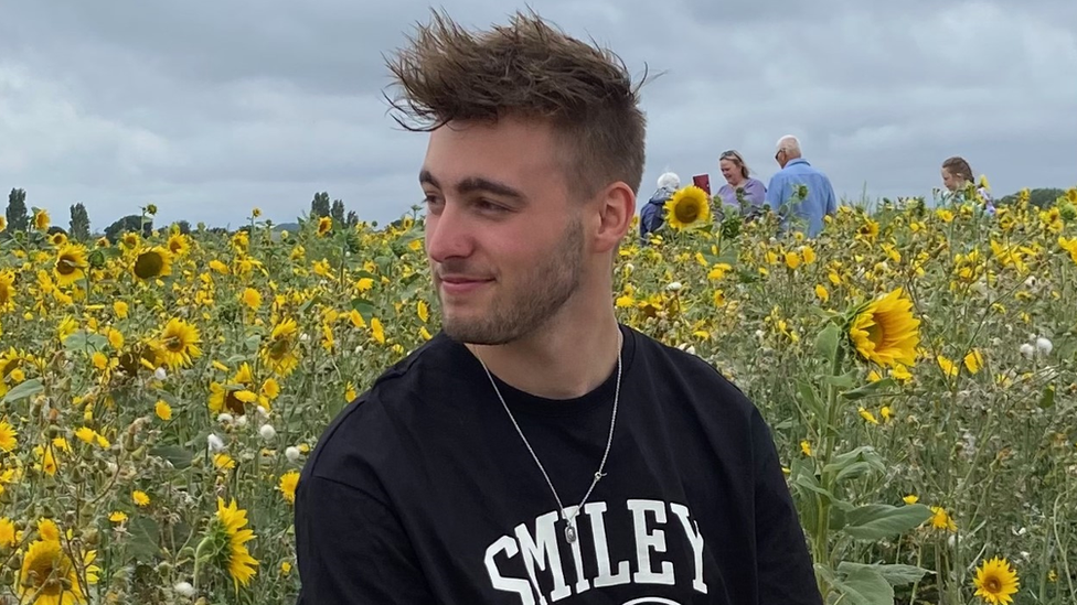 Student Jamie Chevalier-Watts sitting in a field