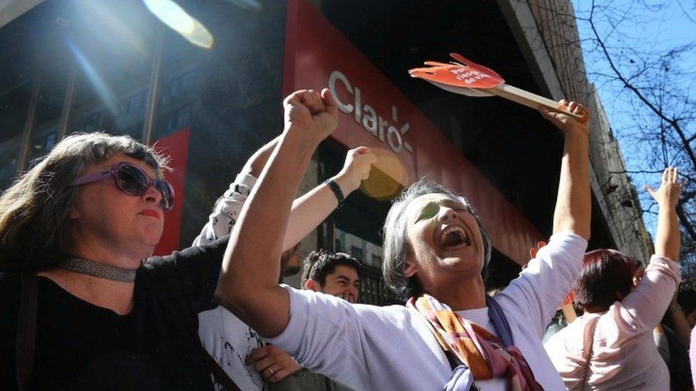 Demonstrators in favour of abortion celebrate after the members of a constitutional court ruled that a law legalising abortion in certain cases is constitutional at Santiago