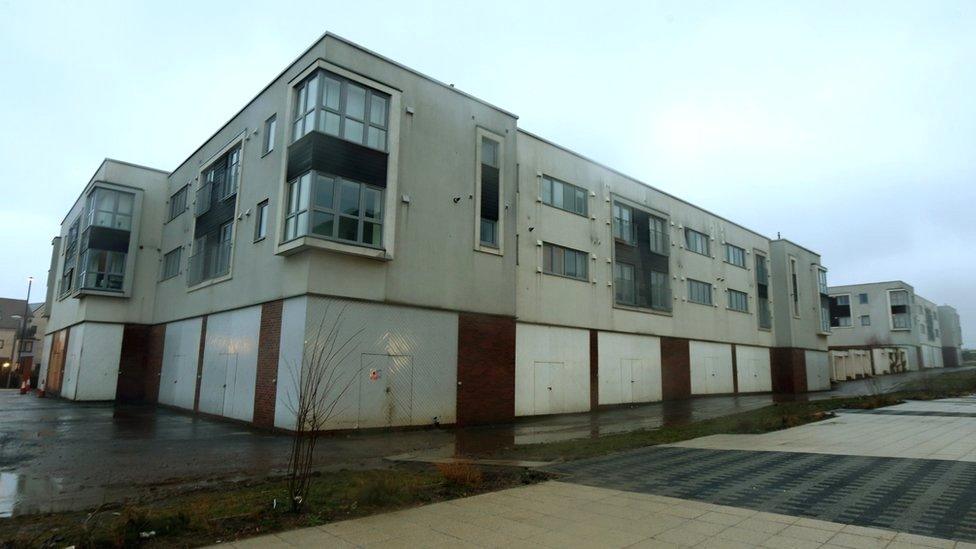 Boarded up shop fronts at the Great Park development