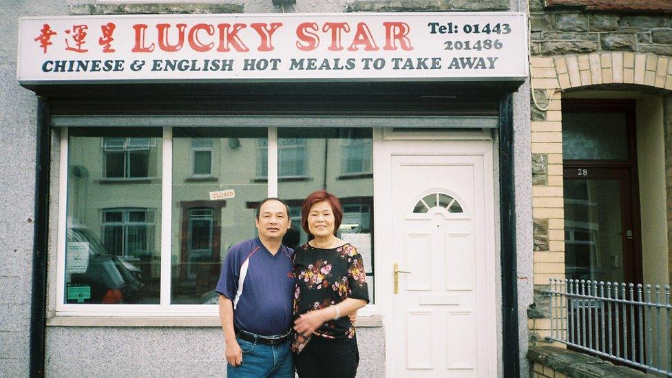 Angela's parents outside their shop on their last day of service in August 2018