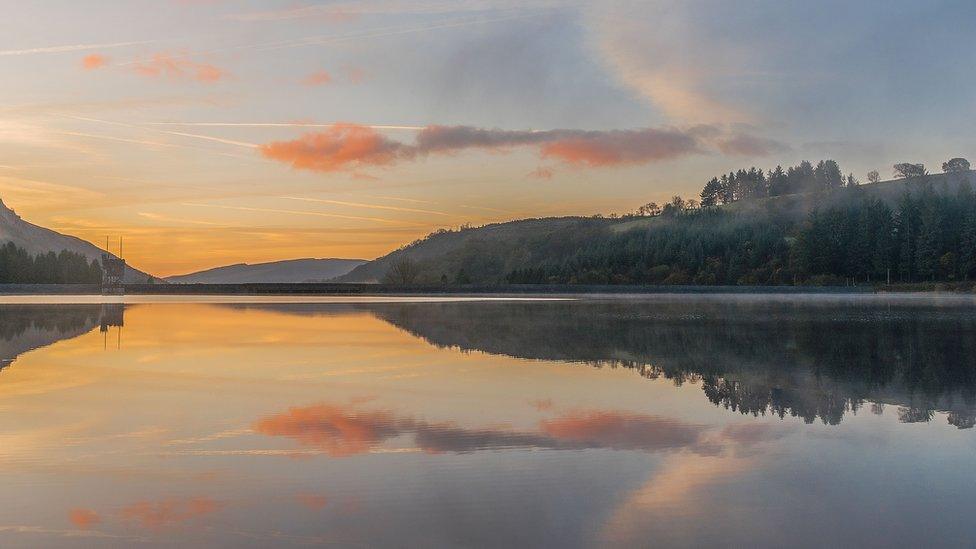 First light over a mirror like Llwn-on Reservoir, Merthyr Tydfil