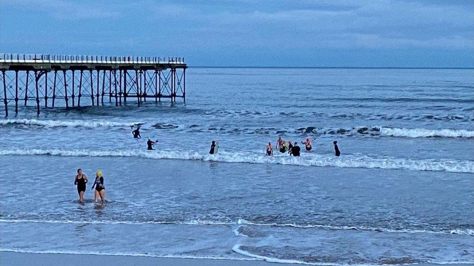 Saltburn Sea Swimmers next to pier