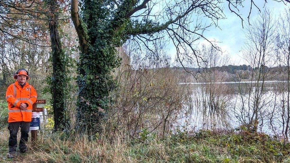 Simon Hughes next to trees and Blagdon Lake