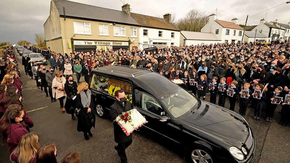 Mourners walk beside the hearse as the cortege arrives at St Brigid's Church, Mountbolus, Co Offaly, Ireland, for the funeral of Ashling Murphy, on 18 January 2022