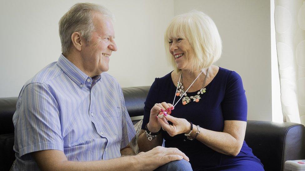 A couple using a pendant alarm