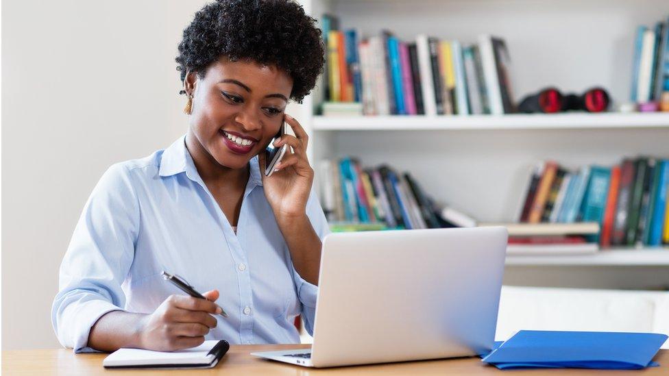 An African woman working at a computer