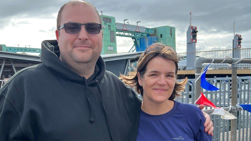 Philip Clark stands with his arm around Susie Jupp in front of Poole's lifting bridge