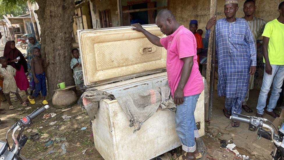 Man looking inside a chest freezer