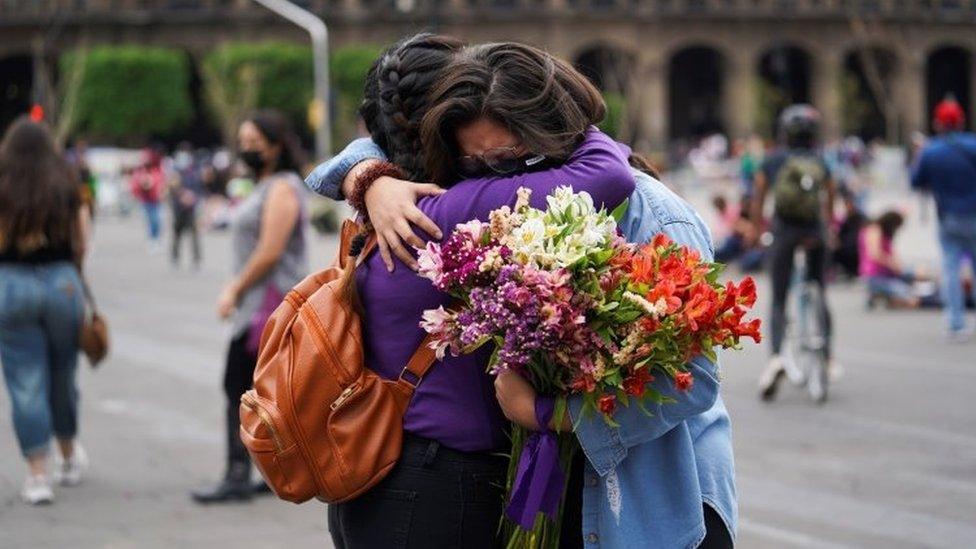 Women embrace outside the National Palace ahead of a Women's Day protest in Mexico City, Mexico March 7, 2021.