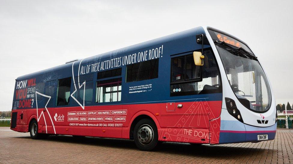 Bus parked on a forecourt