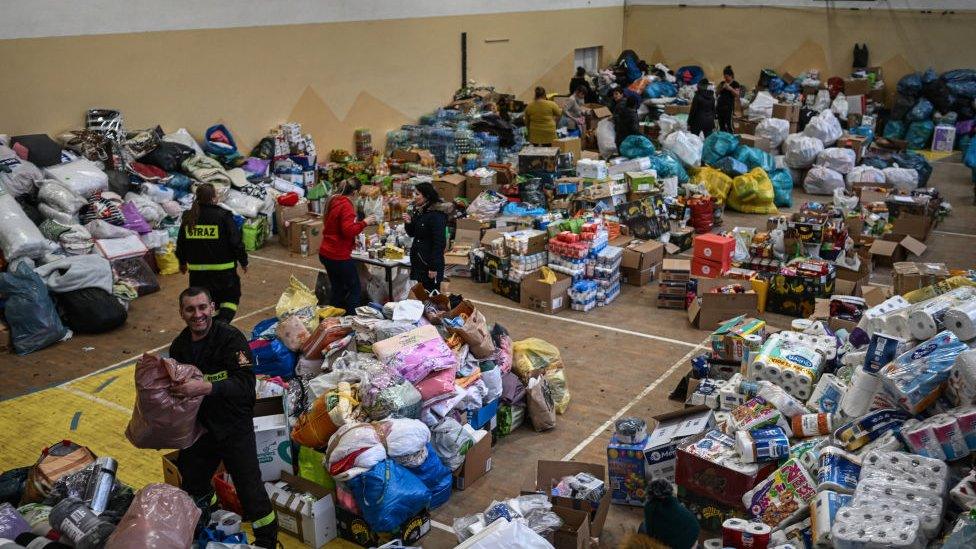 Polish citizens organize individual packages from aid donations inside a sports hall located a few kilometers from the the border crossing point on February 27, 2022 in Kroscienko, Poland. According to the Polish border guard latest report ,more than 213, 000 people have crossed the border into Poland from Ukraine in the first four days of the Russian invasion.