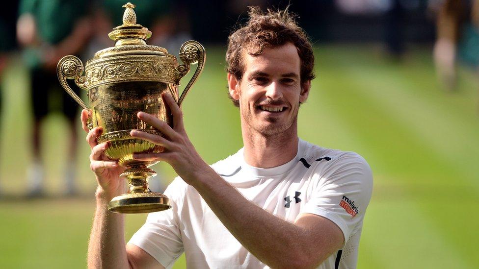 Andy-Murray-holds-up-trophy-at-Wimbledon