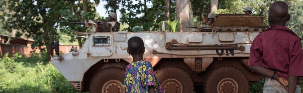 Children observe a Moroccan UN armoured vehicle at the displaced muslims refugee camp of the Catholic minor seminary in Bangassou, south-eastern Central African Republic - August 2017