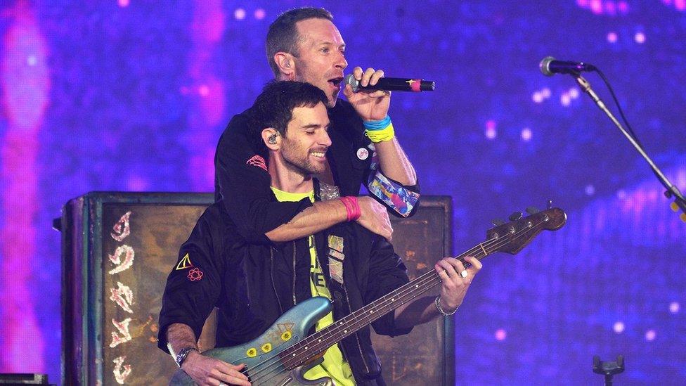 Guy Berryman and Chris Martin of Coldplay on stage