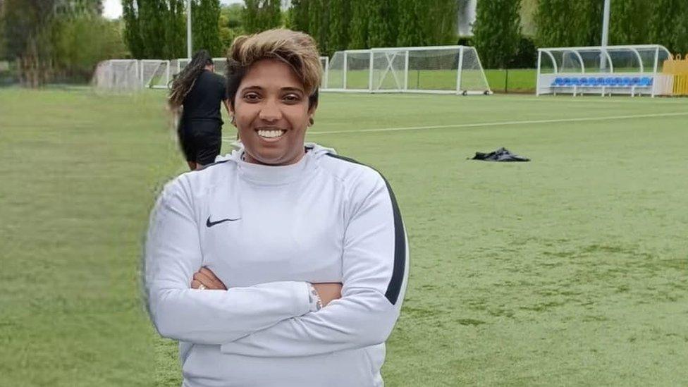 Varsha Bailey-Gunputh standing on a football training pitch.