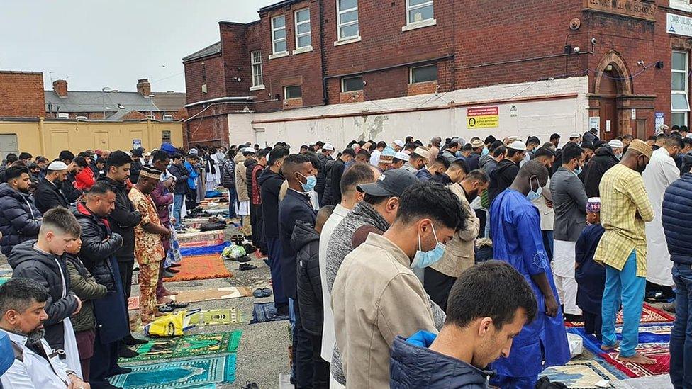 Worshippers praying outside the Central Masjid