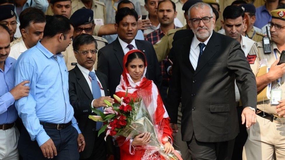 Deaf-mute Indian women "Geeta" (C) is escorted by officials as she leaves the Arrivals Hall of Indira Gandhi International Airport in New Delhi on October 26, 2015, after arriving from the Pakistani city of Karachi.