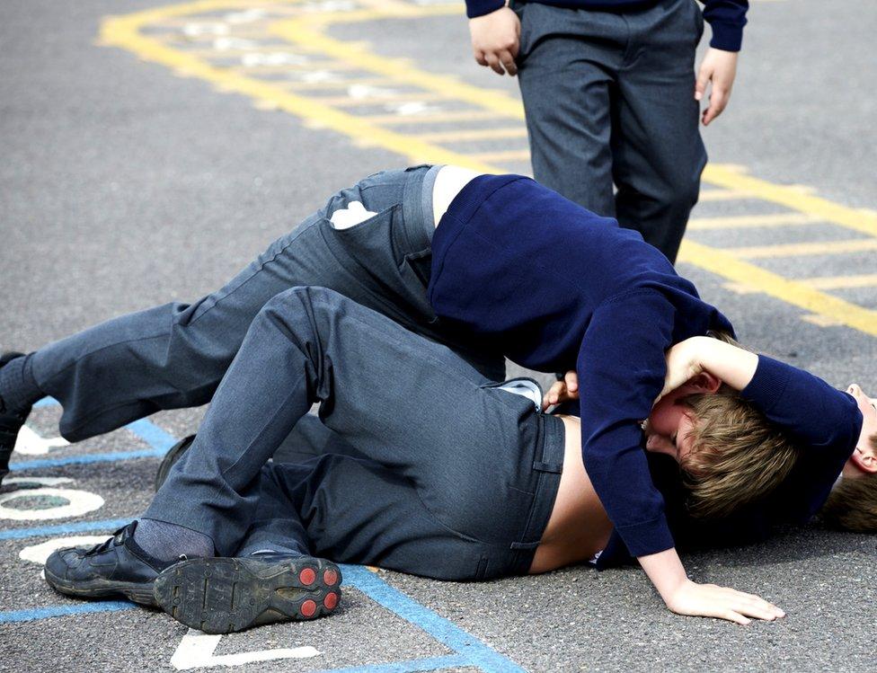 Two schoolboys fighting