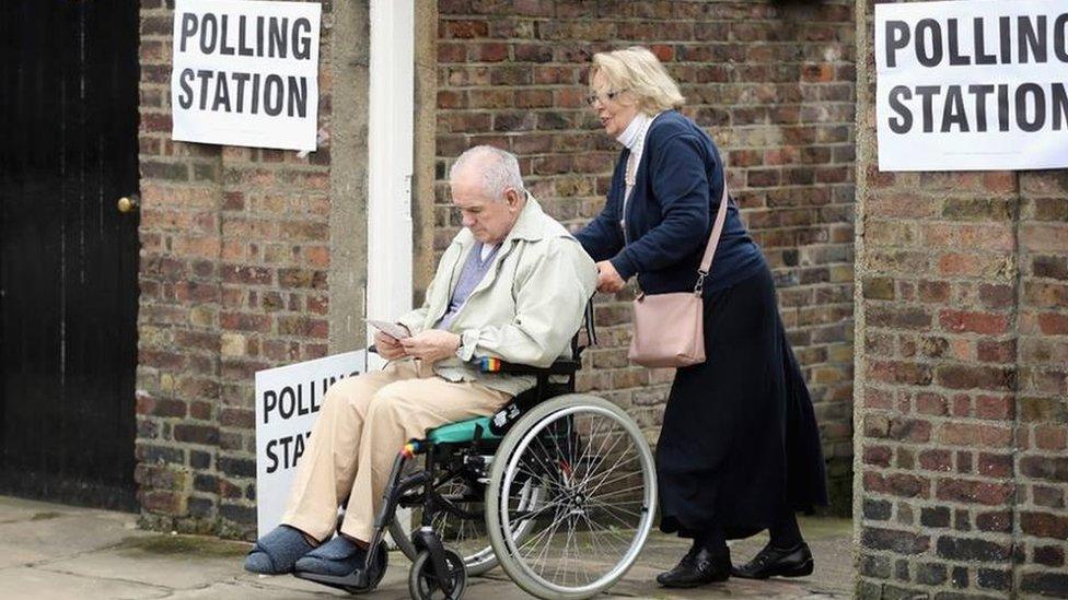 Wheelchair user visits a polling station