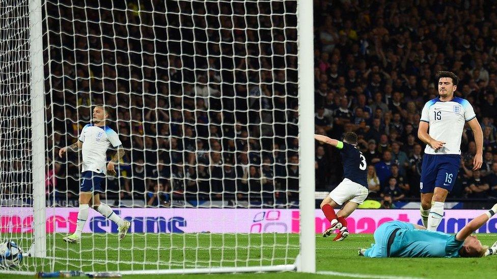 Harry Maguire (right) scores an own goal while playing for England against Scotland