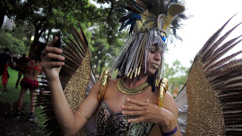 A costumed participant in golden feathered wings and headdress takes a selfie during the annual Sydney Gay and Lesbian Mardi Gras festival in Sydney, Australia March 4, 2017.