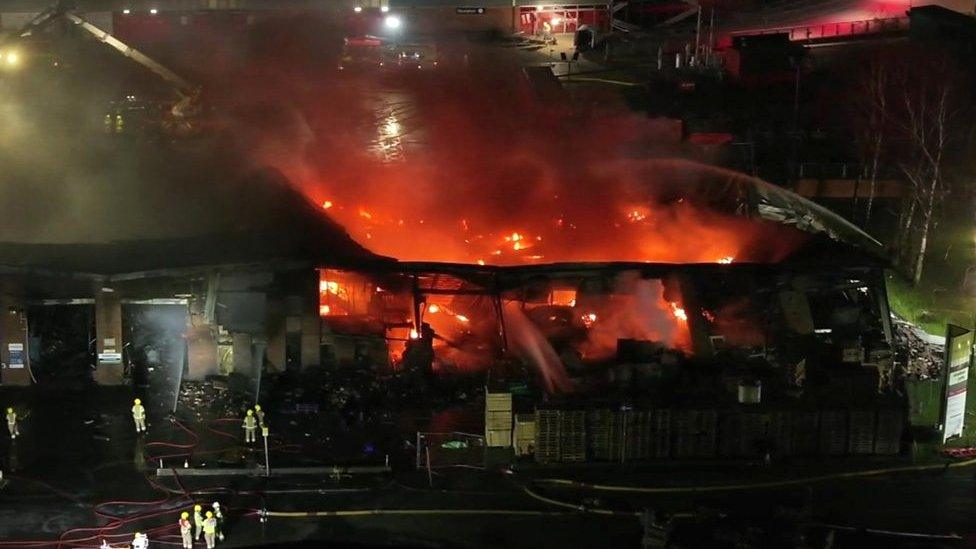 Flames through roof of building