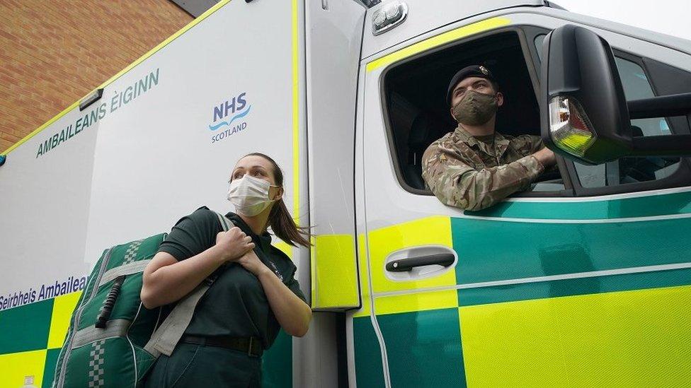 Paramedic with soldier at ambulance