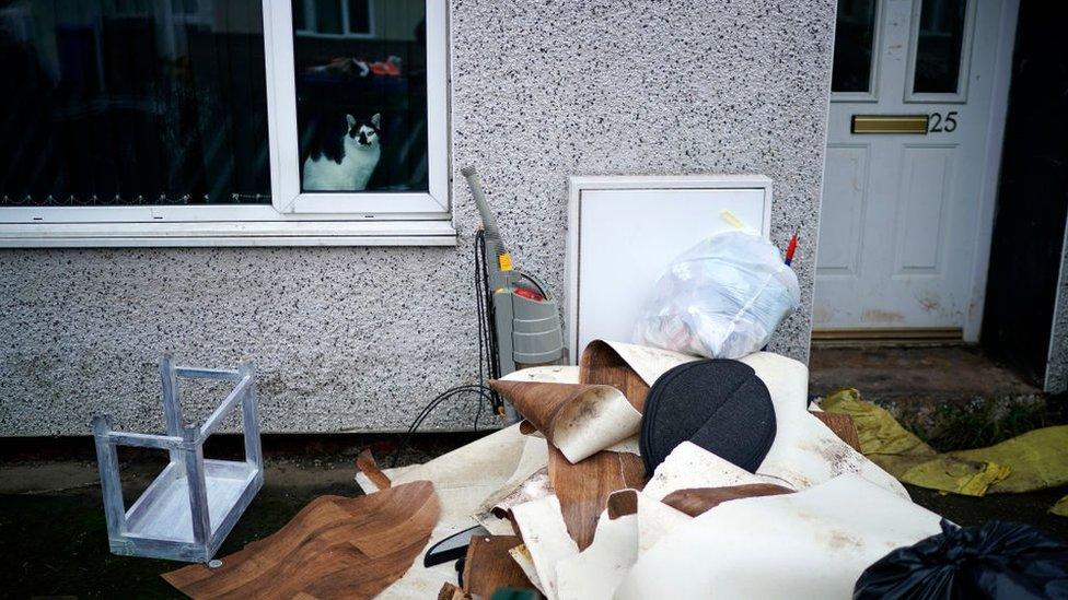 Damaged property outside a flooded home