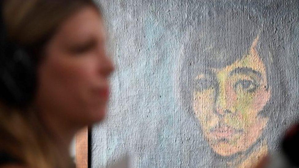 A woman is interviewed during the press preview of the first masterpieces of the estate of German collector Cornelius Gurlitt at the Museum of Fine Arts Bern (7 July 2017)