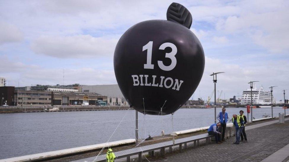 A balloon depicting Apple inc, is tethered before a protest against household water charges, by demonstrators urging the Irish Government to accept the European Commission's Apple tax ruling of €13bn (£10bn) in unpaid taxes (17 September 2016)