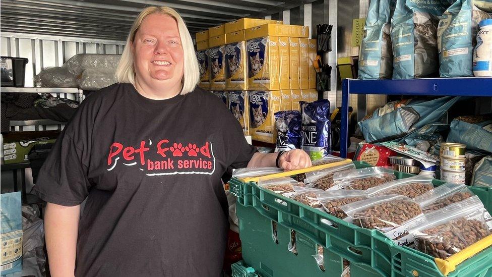 woman stand beside pet food