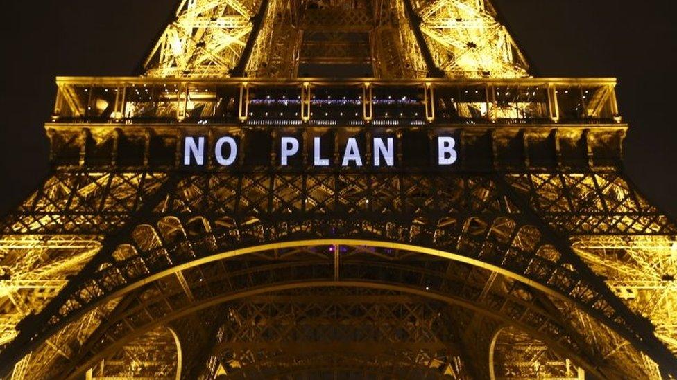 A slogan "No plan B" is projected on the Eiffel Tower as part of the COP21