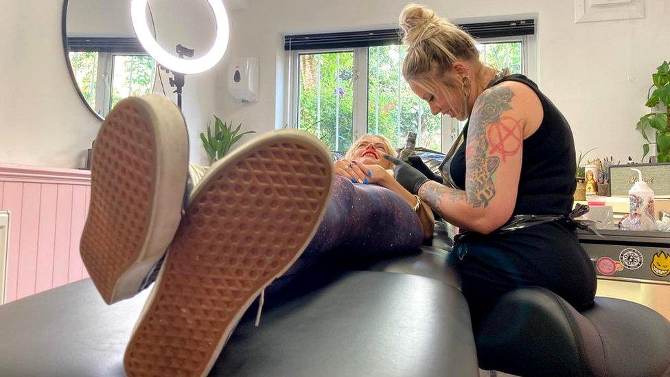 Tanya Buxton working on a tattoo client