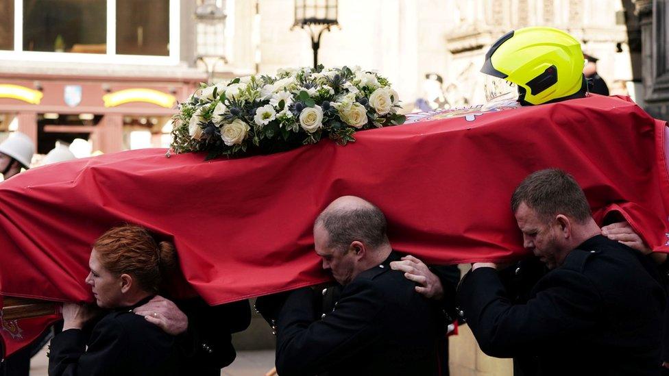 The coffin is carried from the cathedral