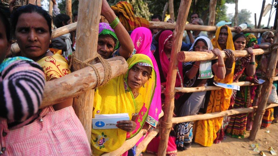 Indian villagers queue outside a bank as they wait to deposit and exchange 500 and 1000 rupee notes in Hanuman Ganj village on the outskirts of Allahabad on November 18, 2016