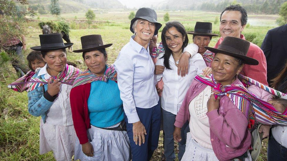 : In this handout provided by the International Monetary Fund (IMF), Managing Director Christine Lagarde (3rd L), Peru first lady Nadine Heredia (white shirt) and and Peru Finance Minister Alonso Segura Vasi (R, rear) pose with locals on a tour of the community December 3, 2014 in Ayacucho, Peru