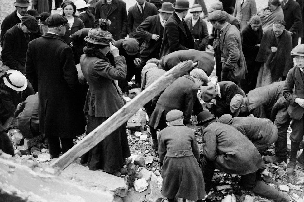 Souvenir hunters of all ages scrabble amongst the rubble in the streets of Dublin