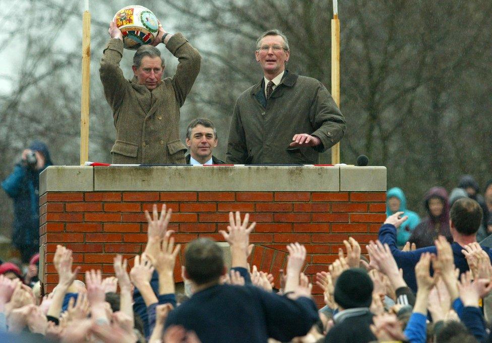 Prince Charles prepares to "turn up" the ceremonial ball before starting the ancient Royal Shrovetide Football game, in Ashbourne, Derbyshire